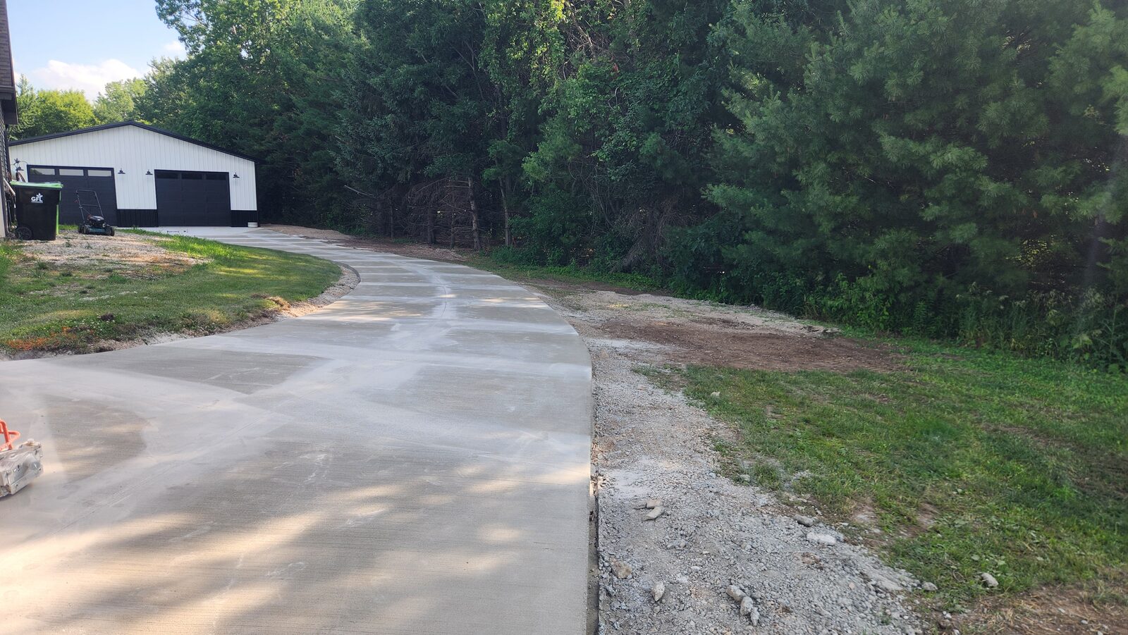 New concrete driveway poured by NAK Concrete leading to a pole barn in Northeast Wisconsin